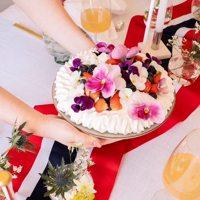 Decorate the table for May 17th with flowers and decorations in red, white, and blue