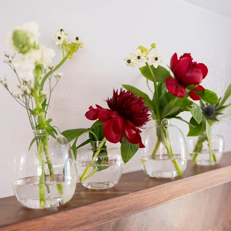 Decorate the table for May 17th with flowers and decorations in red, white, and blue